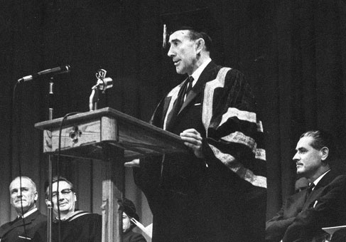 Early black and white convocation image - man at a podium