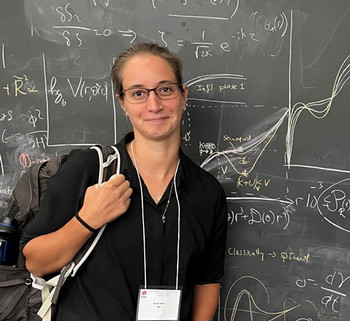 sarah in front of chalkboard